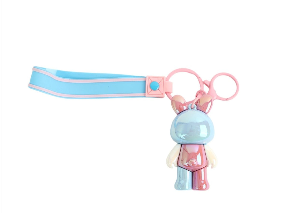 Bunny keychain with striped blue strap, pink loop, and blue rabbit charm.