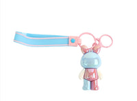 Bunny keychain with striped blue strap, pink loop, and blue rabbit charm.