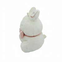 White bunny plush toy with pink ear lining, side view, small front tag