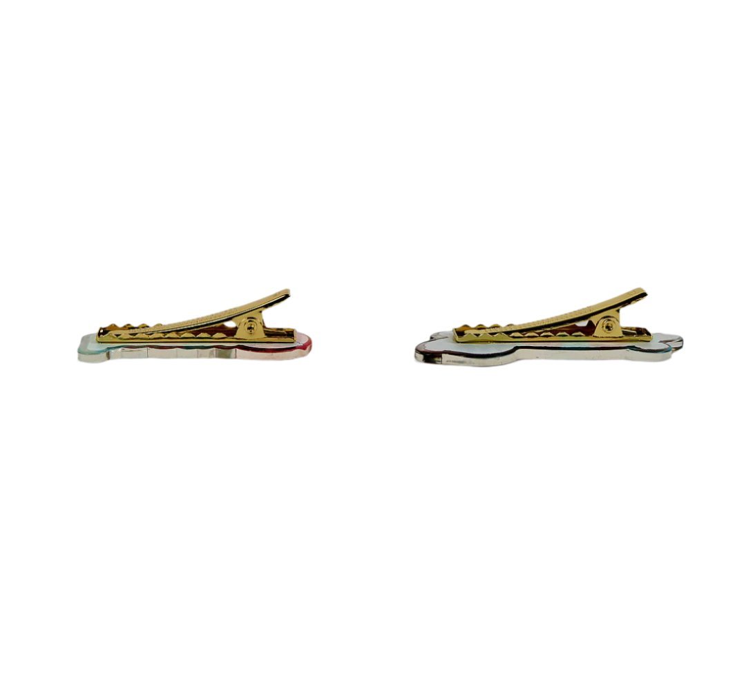 Two cartoon hair clips with gold-tone base and multicolor detail