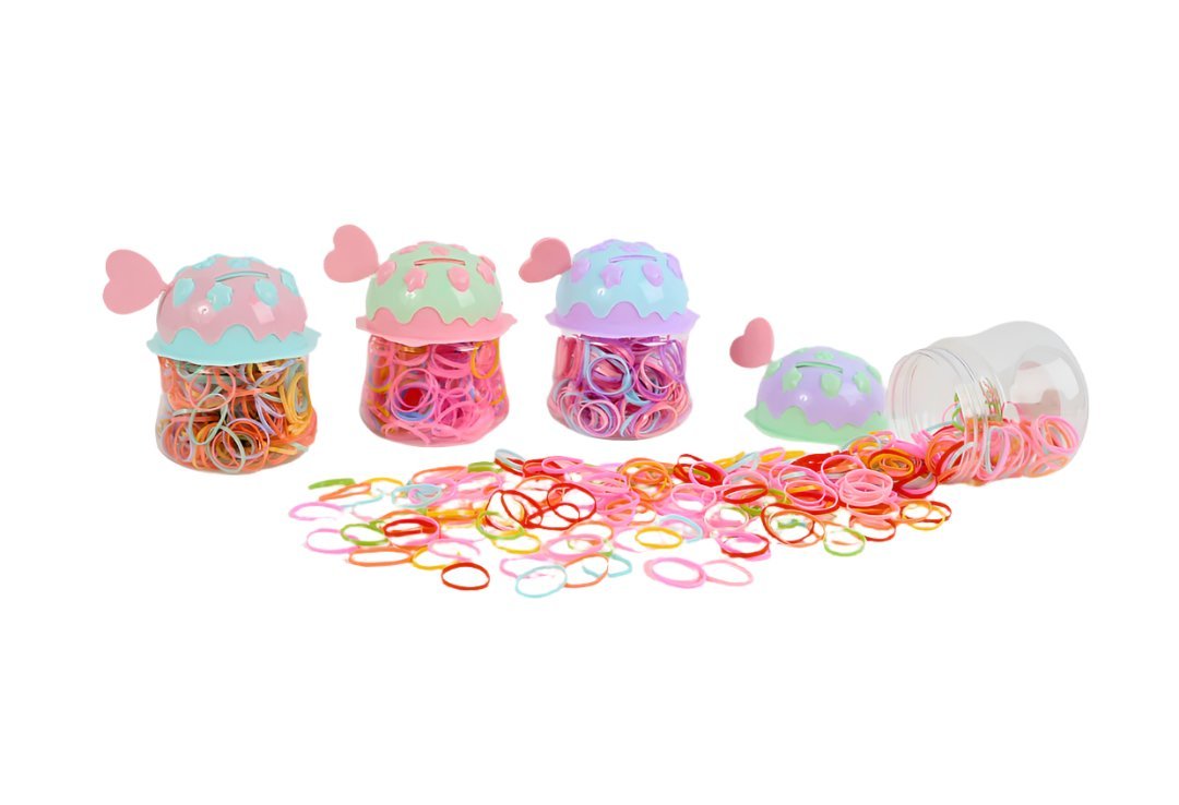 Colored rubber bands with small piggy bank jars and loose bands scattered