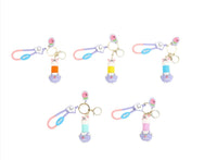 Set of rabbit cartoon keychains with mixed charms, pink and blue accents, gold rings