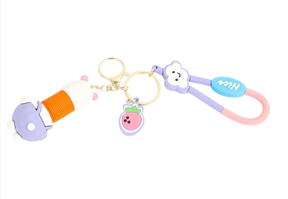 Rabbit and pig charm keychain with gold rings, purple bunny tag, pink strap, orange spool