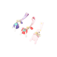 Cartoon fruit keychains with straps, pink plush characters with dangling charms and rings.