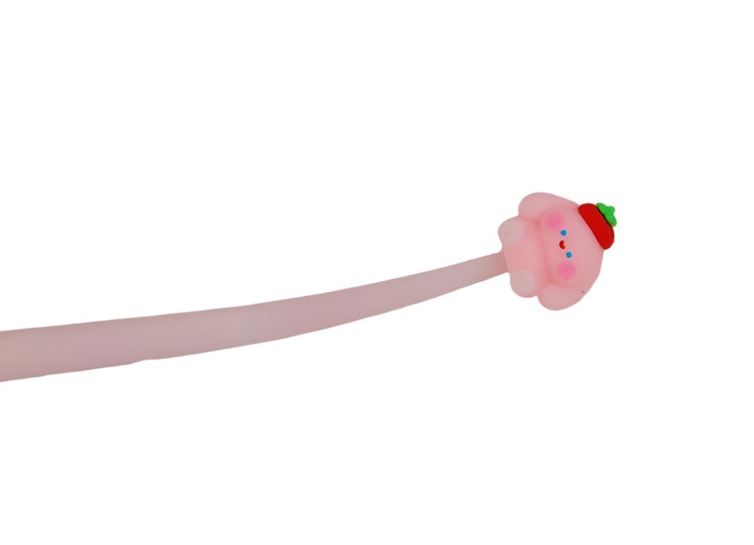 Pink cartoon pen close-up with animal topper and small face details