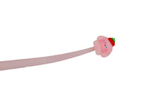 Pink cartoon pen close-up with animal topper and small face details
