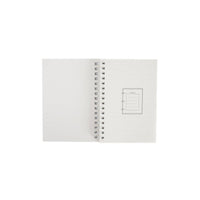 Dinosaur A6 coil notebook back pages, white spread with coil rings and small label box.