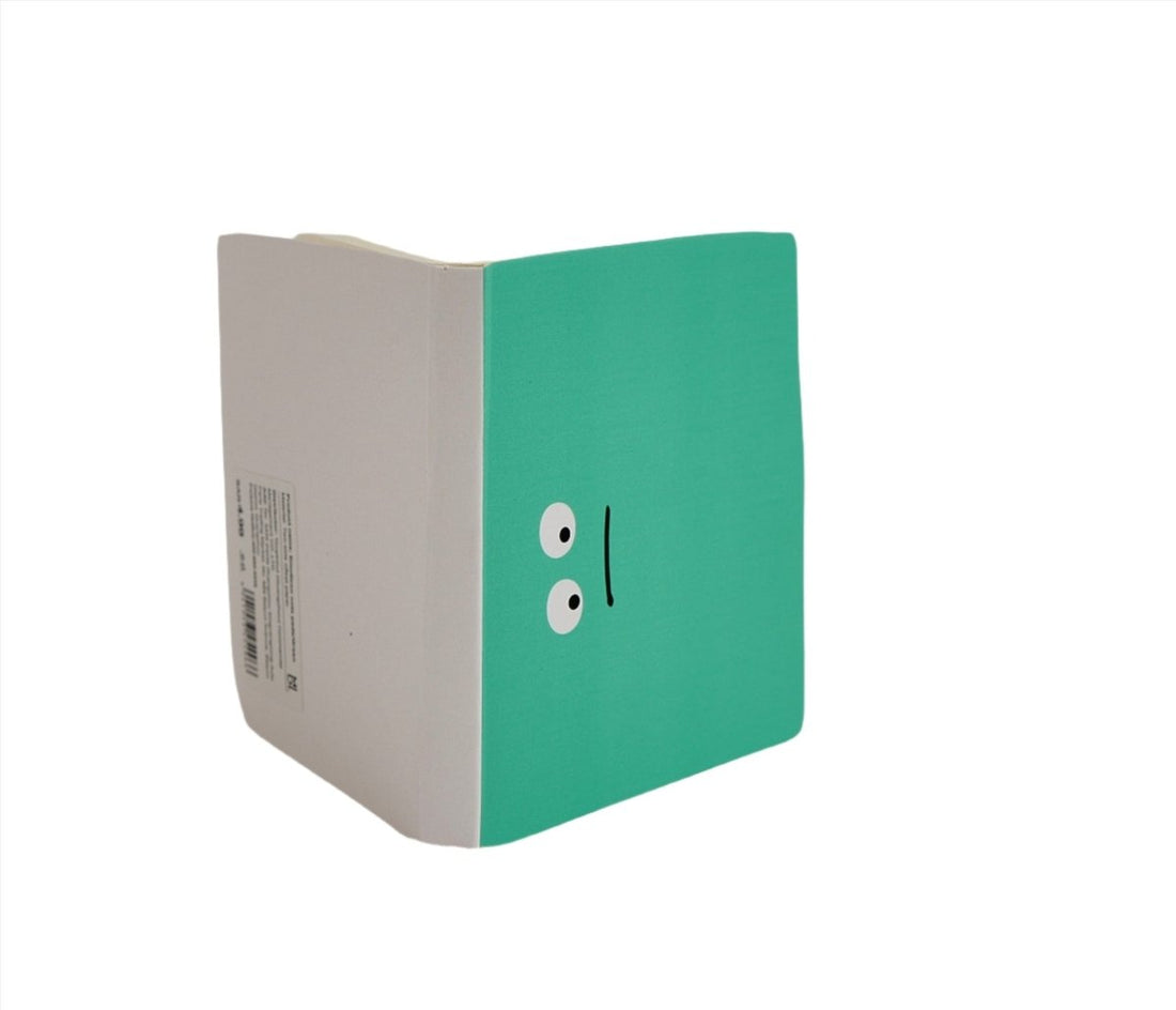 Green notebook with cute face graphic, shown from side with white spine