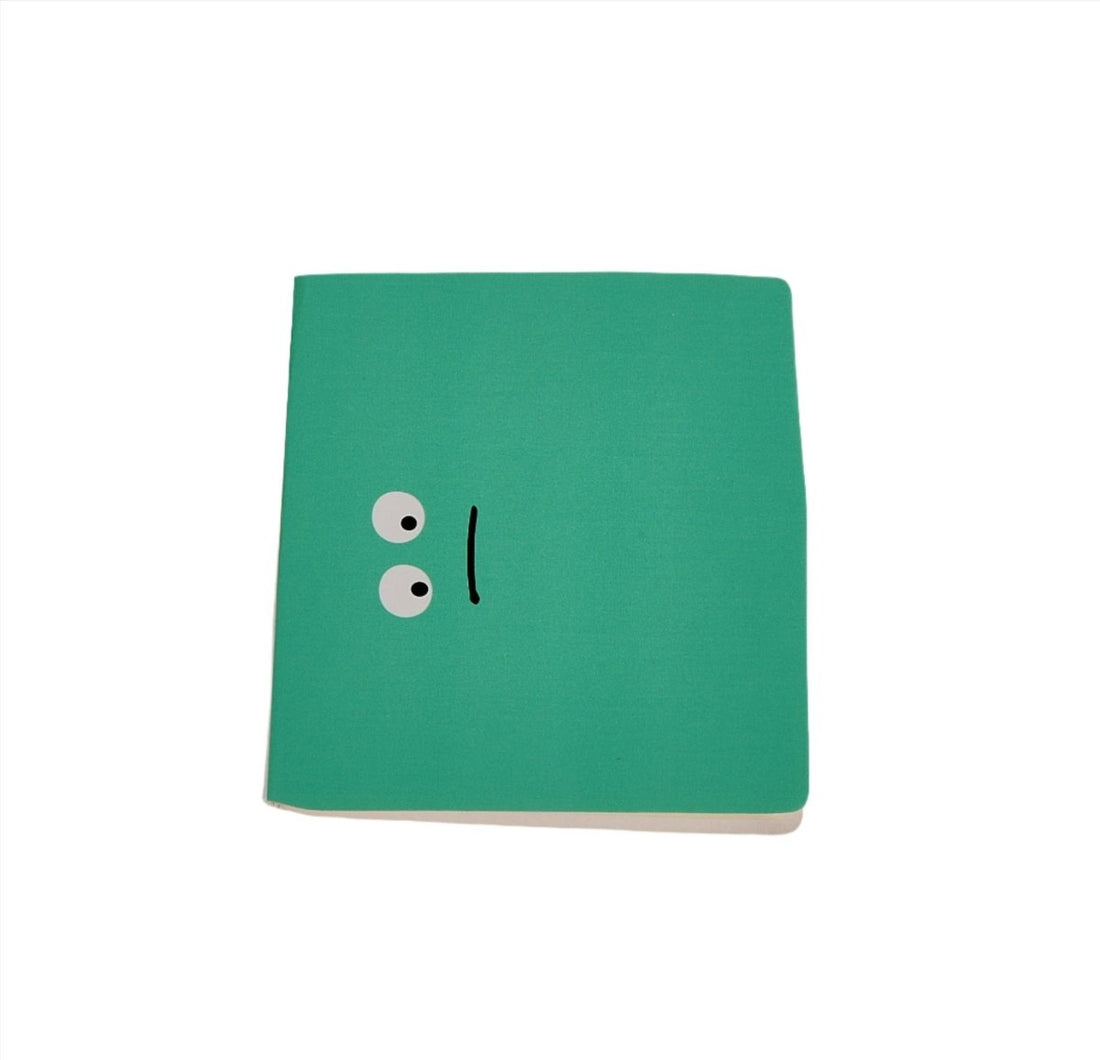 Green notebook with cute face eyes on front cover