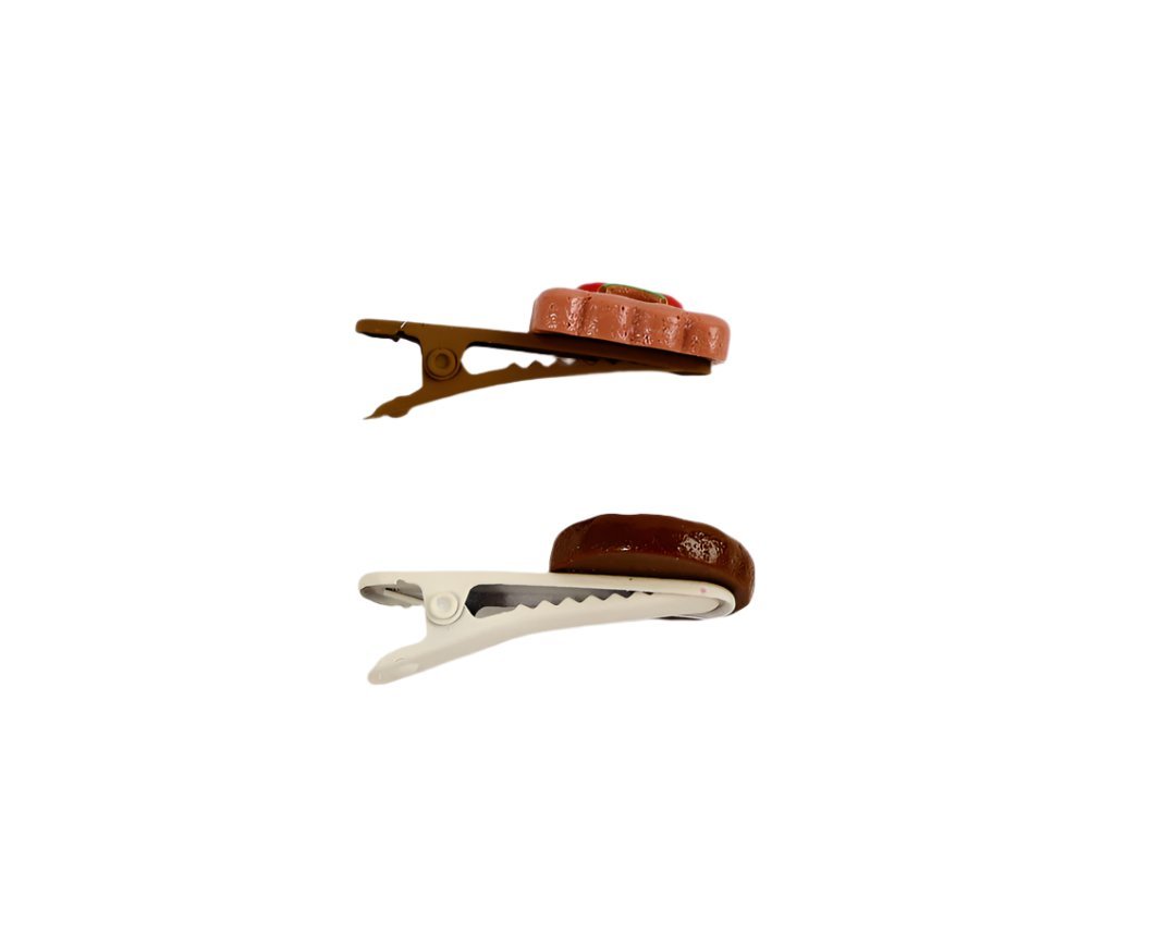 Cartoon hair clips pair: brown cap clip and white clip with brown ridged cap