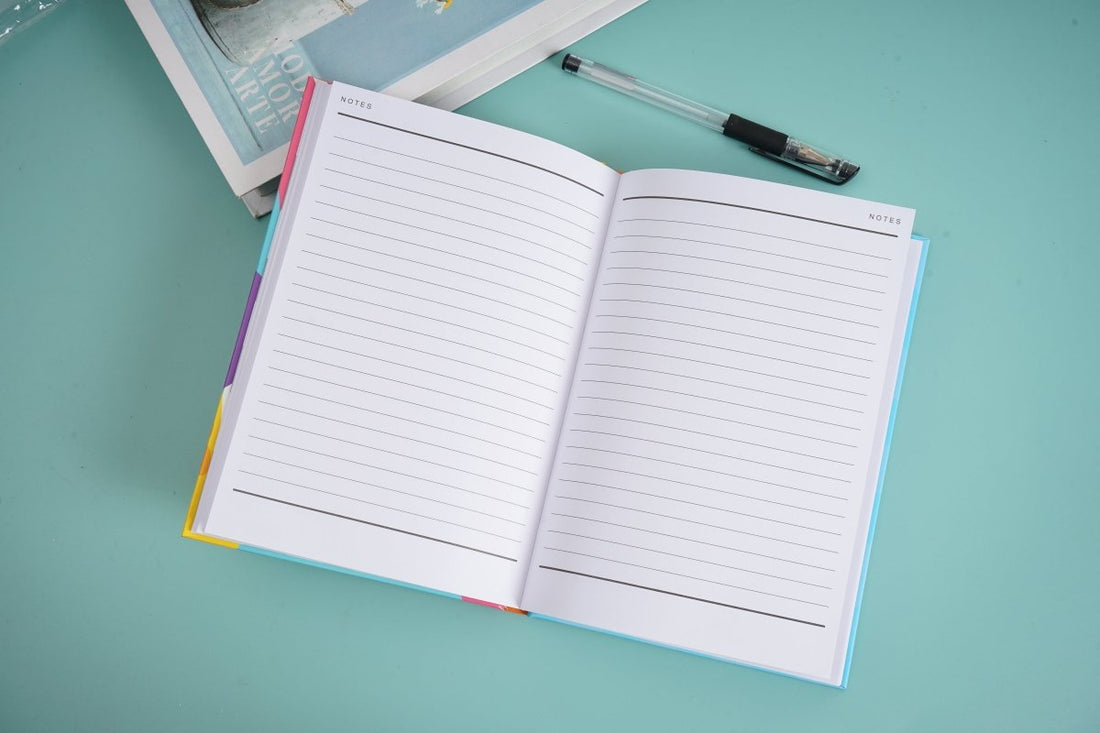 A5 hardback notebook open to lined pages with faint header text.