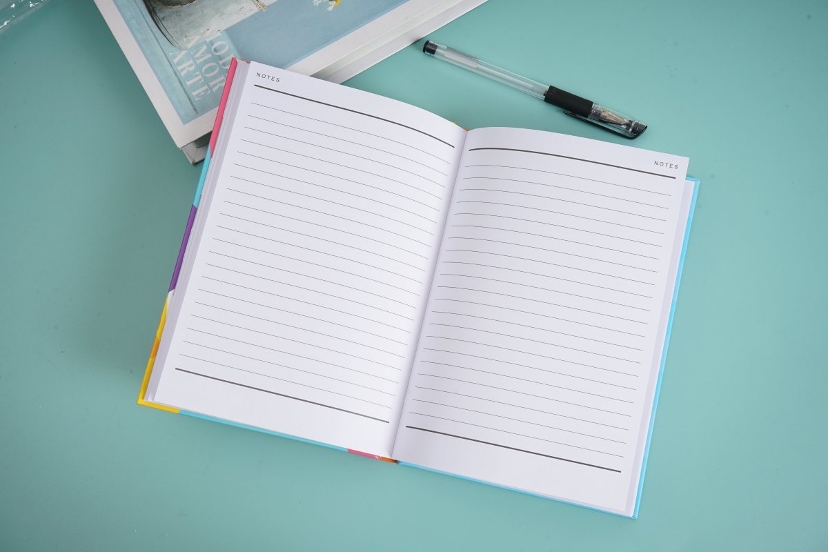 A5 hardback notebook open to lined pages with faint header text.