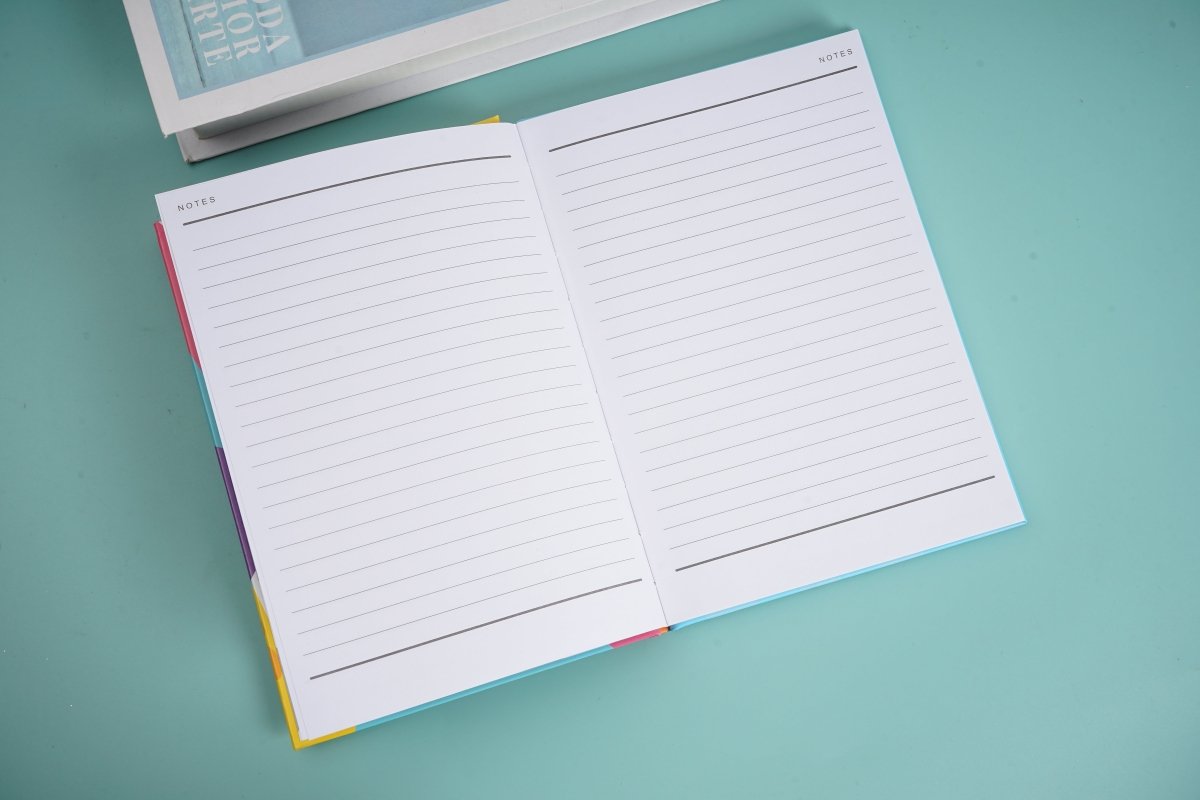 A5 hardback notebook open, two-page spread of lined paper.