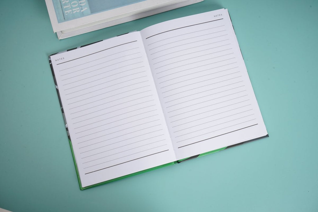 Open notebook with ruled pages and green spine