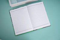 Open notebook with ruled pages and green spine