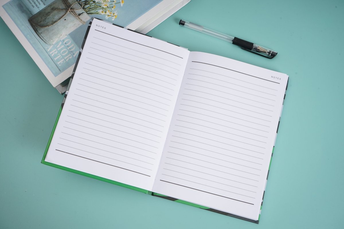 Open notebook with two ruled pages and green border