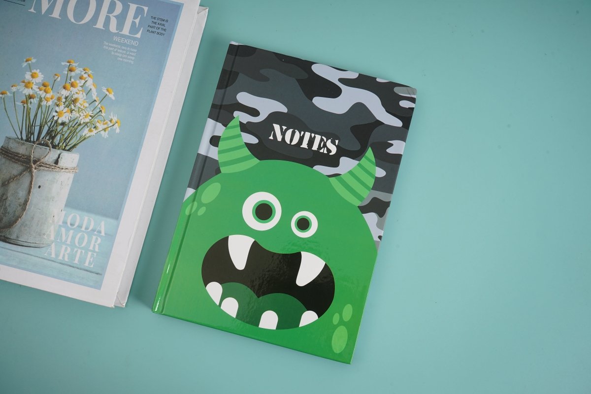 Green monster notebook with smiling face on camo cover