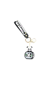 Panda keychain with backpack charm, gold ring, black vertical strap reading 'Good luck'.