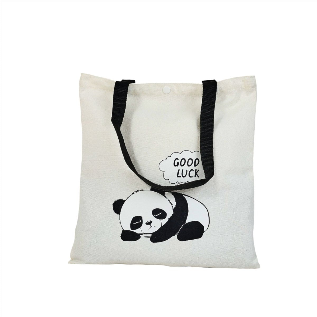 White canvas tote bag with panda and 'GOOD LUCK' bubble, black side straps, buttoned top