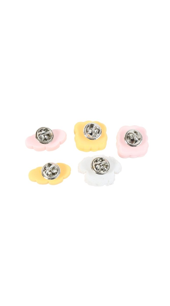 Close-up of pastel pastry and dog pin set with metal backings