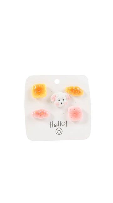 Pastel pastry and dog pin set on clear backing card with six pins