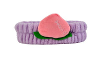 Fuzzy peach-themed headband with lavender band, pink peach slice, and green leaf detail