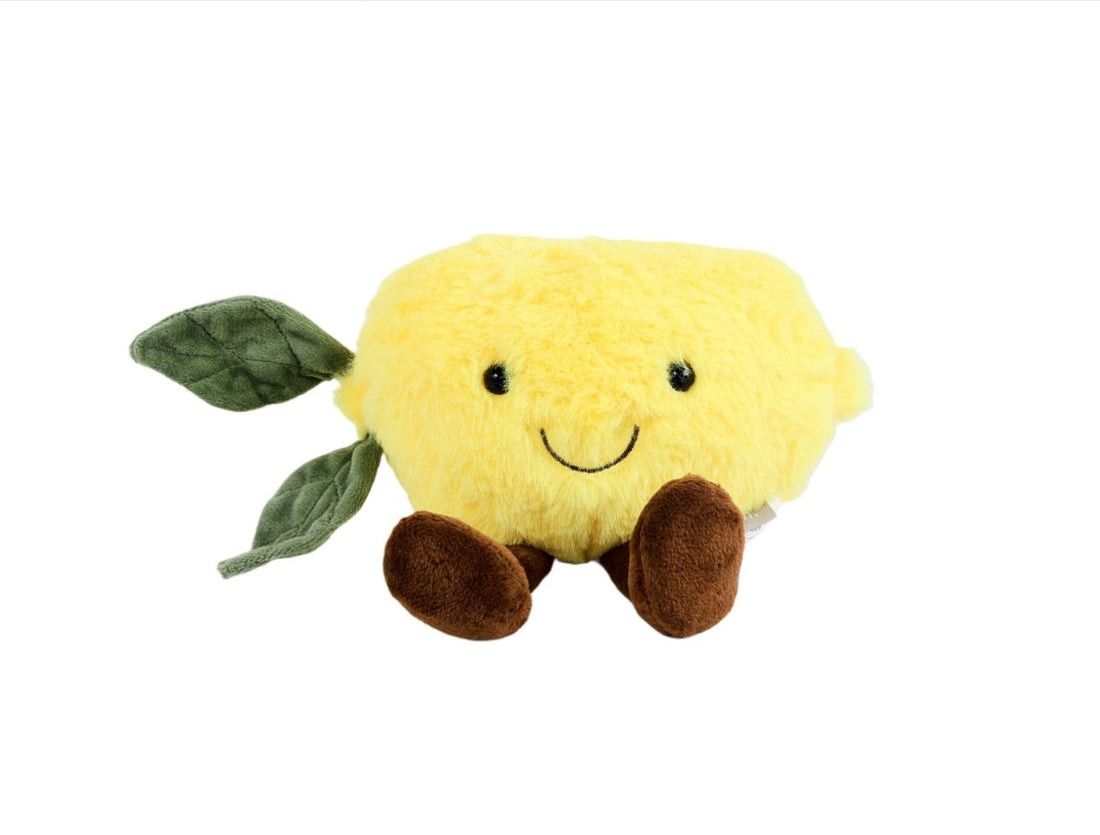 Plush lemon toy with smiling face, green leaf arms and brown feet