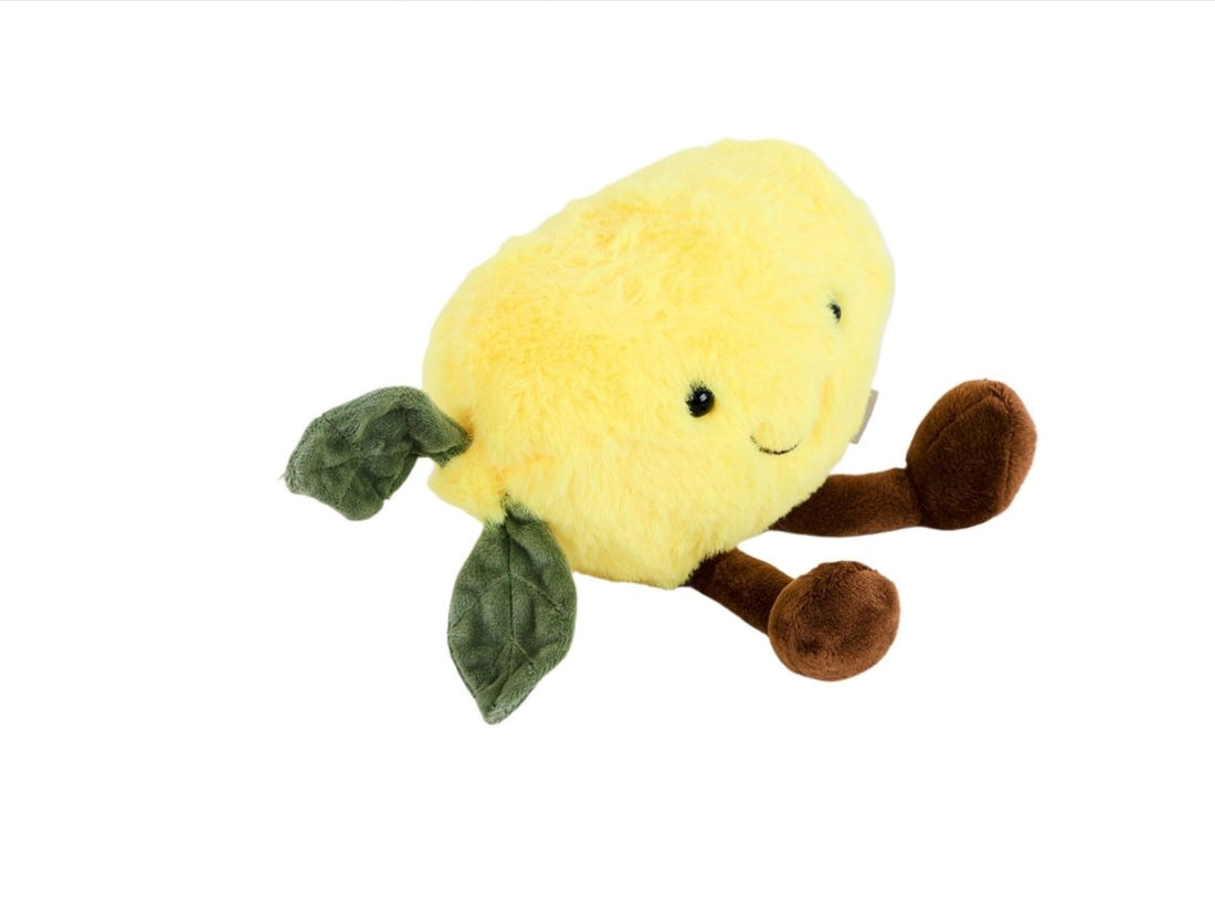 Plush lemon toy with half-profile face, green leaf arms and brown plush feet