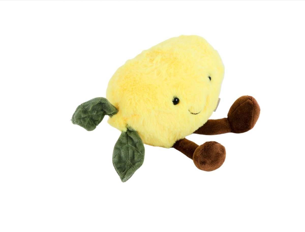 Plush lemon toy with half-profile face, green leaf arms and brown plush feet