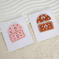 Cookie-themed pencil case on cards, featuring pink and brown smiling cookie face designs.