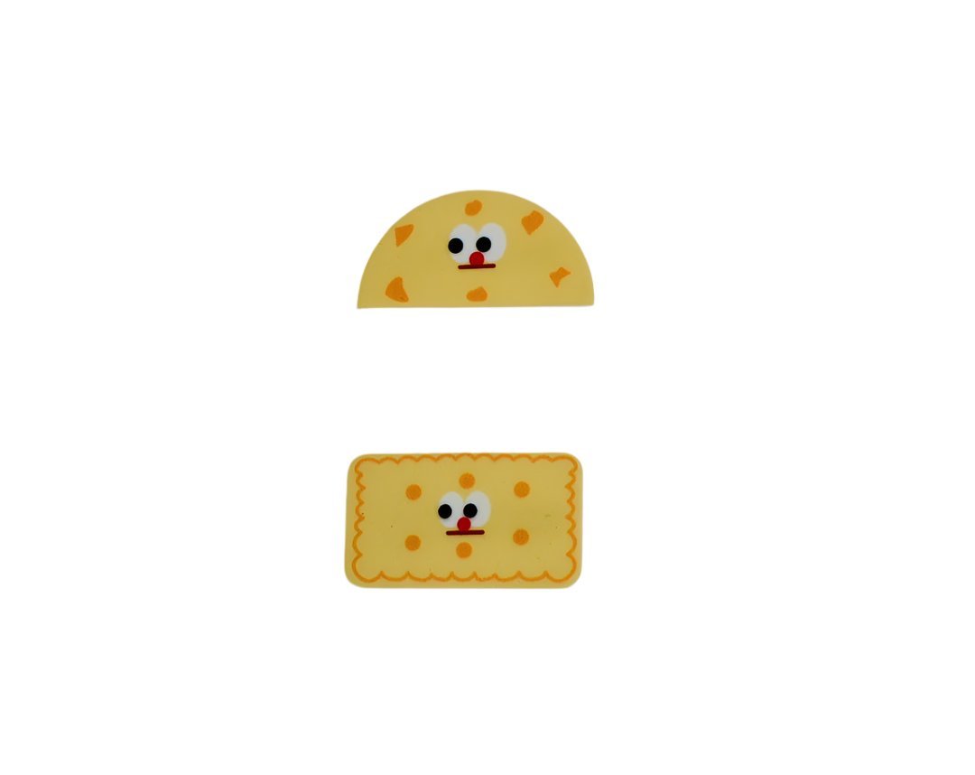 Yellow cookie-themed pencil case with smiling cookie face and dotted crumb pattern.