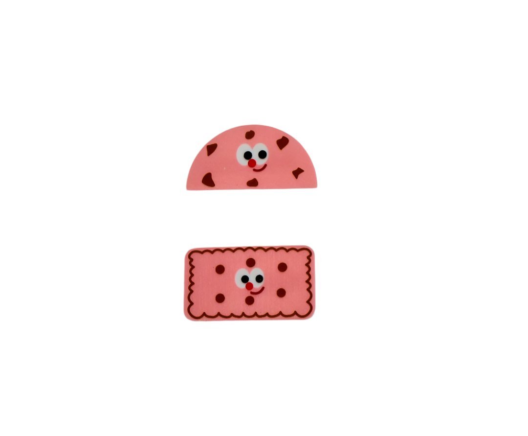 Pink cookie-themed pencil case with smiling cookie face and crumb pattern appliques.