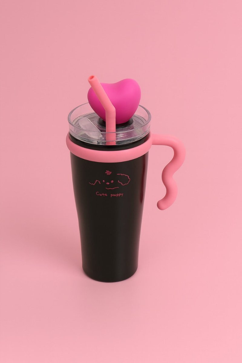 Insulated tumbler with clear lid, pink heart topper and straw, black body, side handle.