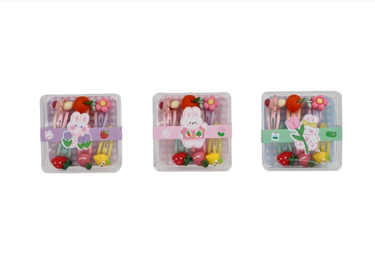 Children's hair clip set shown in three clear boxes with rabbit and garden clips