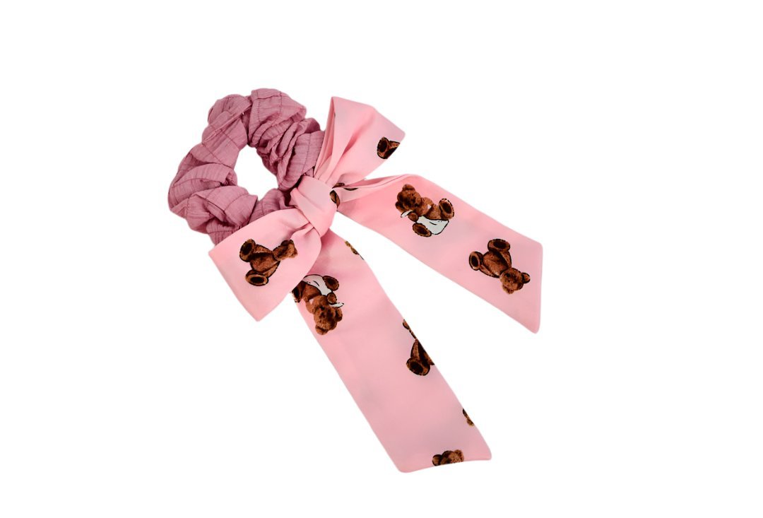 Pink hair scrunchie with teddy-bear bow print ribbon tails and gathered elastic