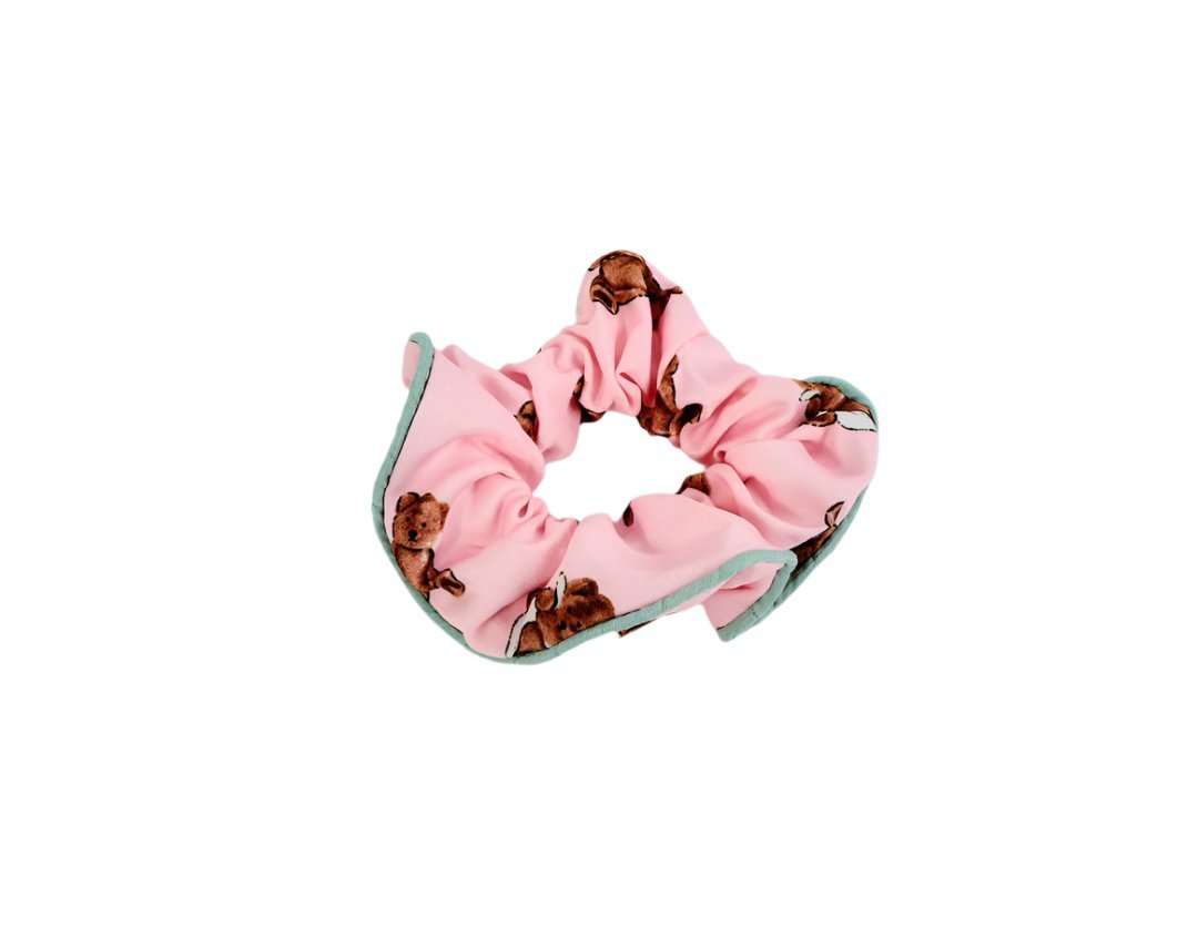 Hair scrunchie in pink fabric with cute bear print, gathered into a loop