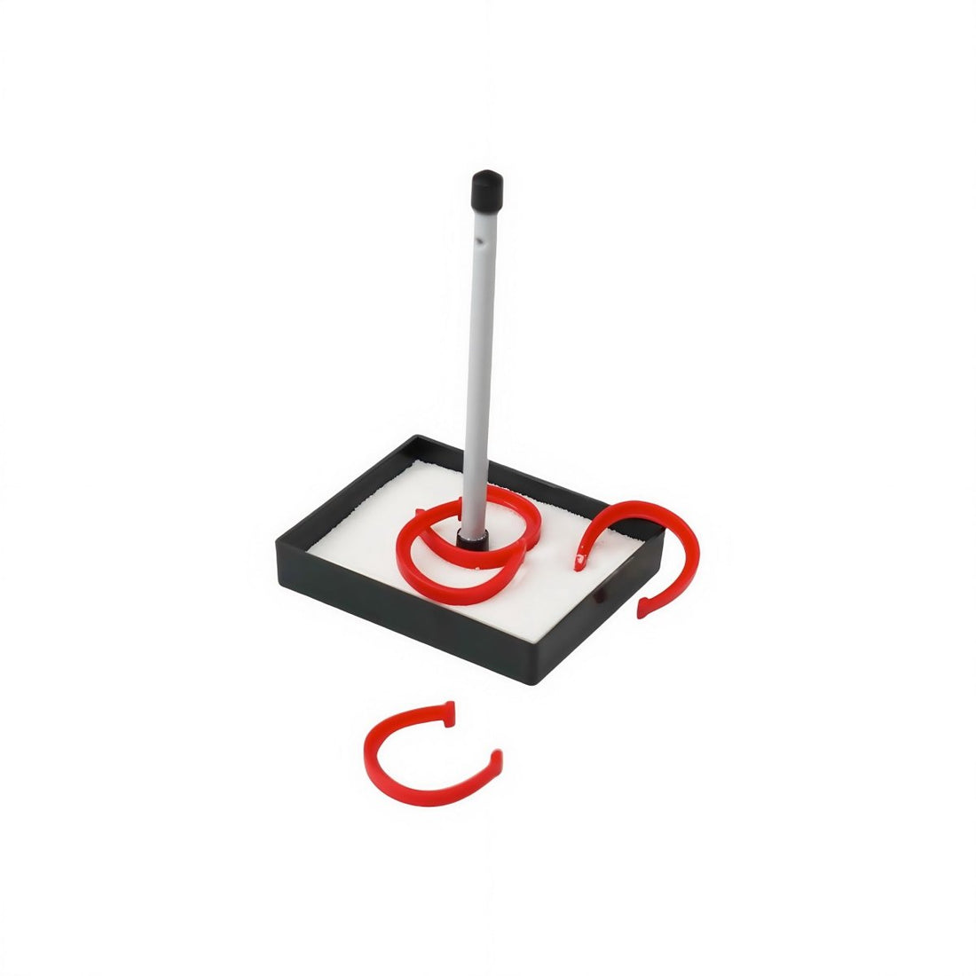 Desktop horseshoes game with black base, white pole, red horseshoes