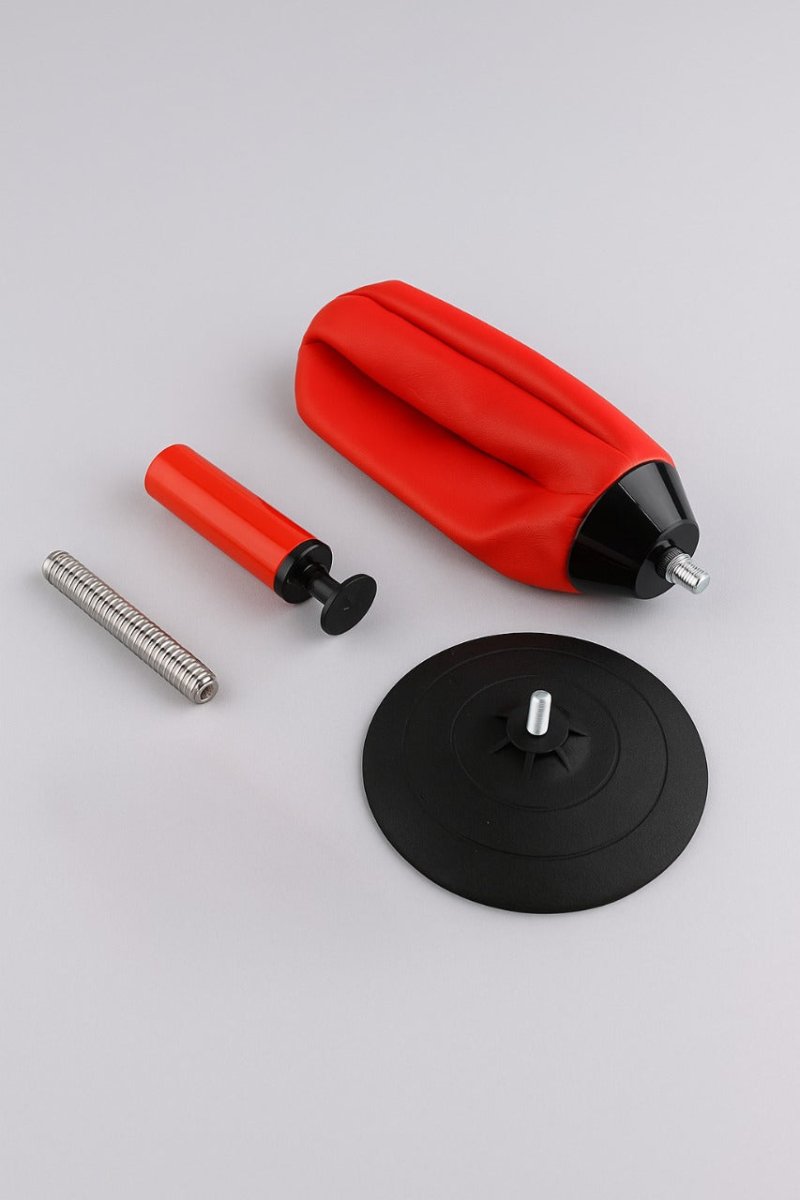 Desktop punching bag with red pad, black base disk, and silver spring stand