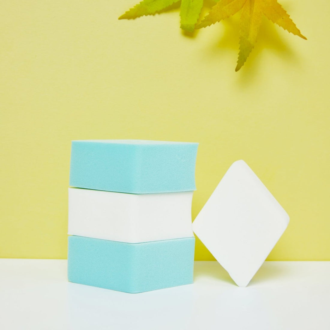 Diamond makeup sponge with white and light blue sponges, plus one standalone wedge