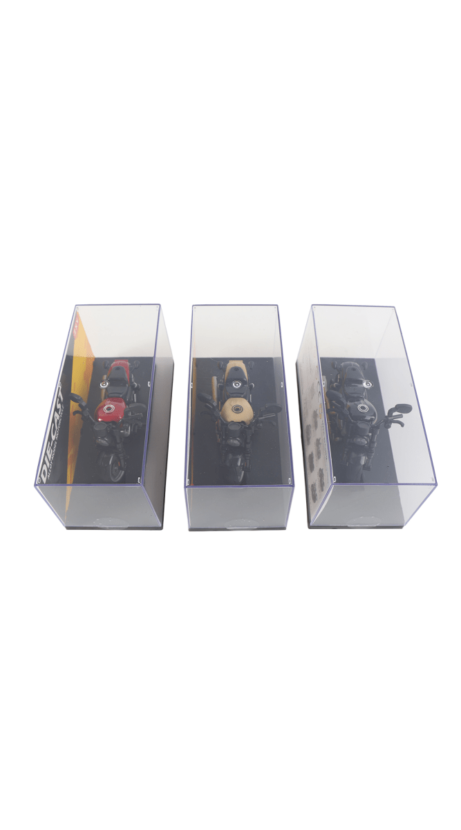Three die-cast motorcycle models in display boxes, front angle views
