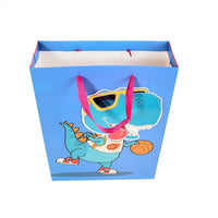 Dinosaur gift bag with cartoon teal dino and pink ears, open top with red handles