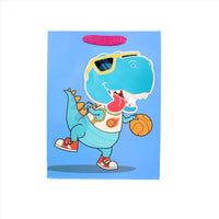 Dinosaur gift bag with cartoon teal dino holding a basketball, blue design panel