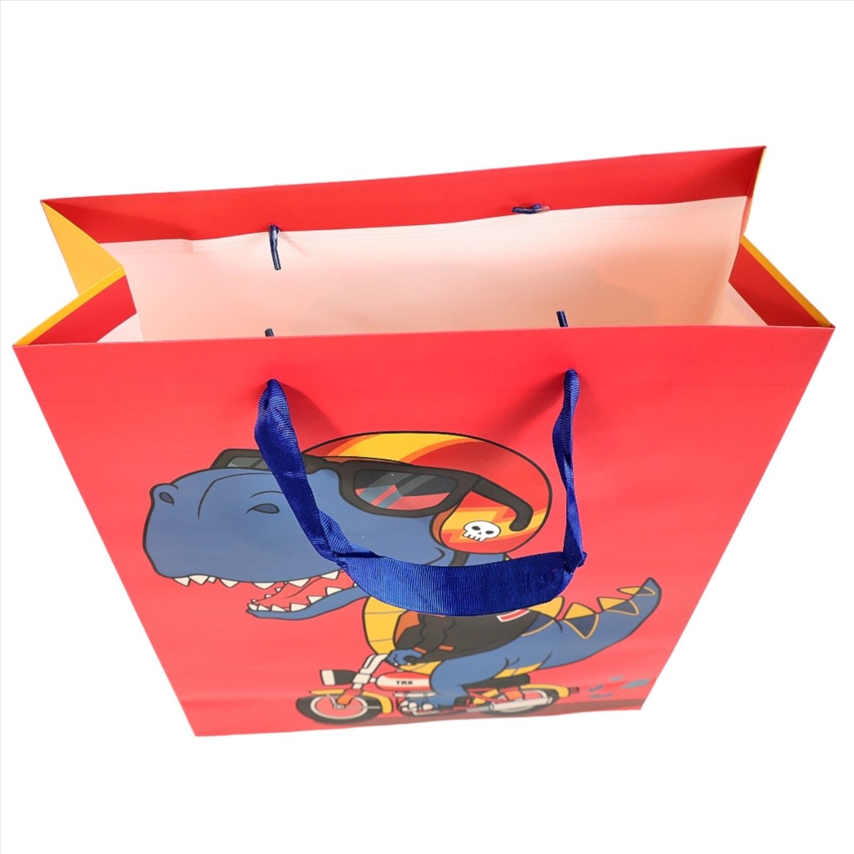 Dinosaur gift bag with cartoon blue dino riding a scooter, open top and red body
