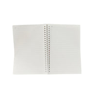 A5 spiral notebook opened flat, lined pages visible with spiral binding