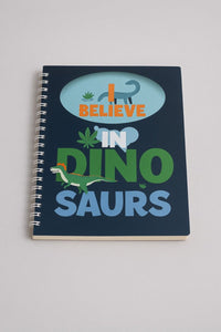 B5 spiral notebook with navy cover, dinosaur graphic, and “BELIEVE IN DINO SAURS” text