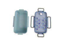 Light blue lunch box with hinged lid and blue dotted front, open view