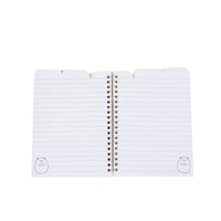 Open spiral notebook with lined pages and gold coil binding