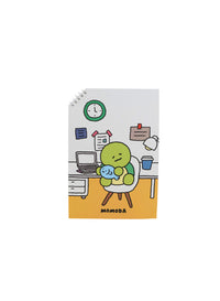 Cartoon spiral notebook cover with green character at desk and clock motif