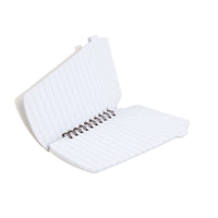 Open white lined spiral notebook with metal rings, showing inner pages