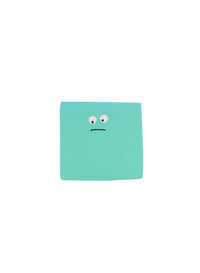 Green mini notepad with sad face emoticon on the cover